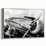 Vintage poster art of a silver airplane on a black background, framed canvas, ideal for living room decor.