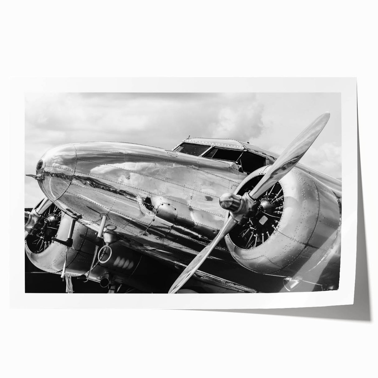 Art deco poster featuring a vintage airplane in muted silver and blue tones, ideal for dining room wall art.