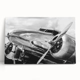 Black and white photo of a vintage airplane on stretched canvas, ideal for kitchen wall art or bedroom ambiance.