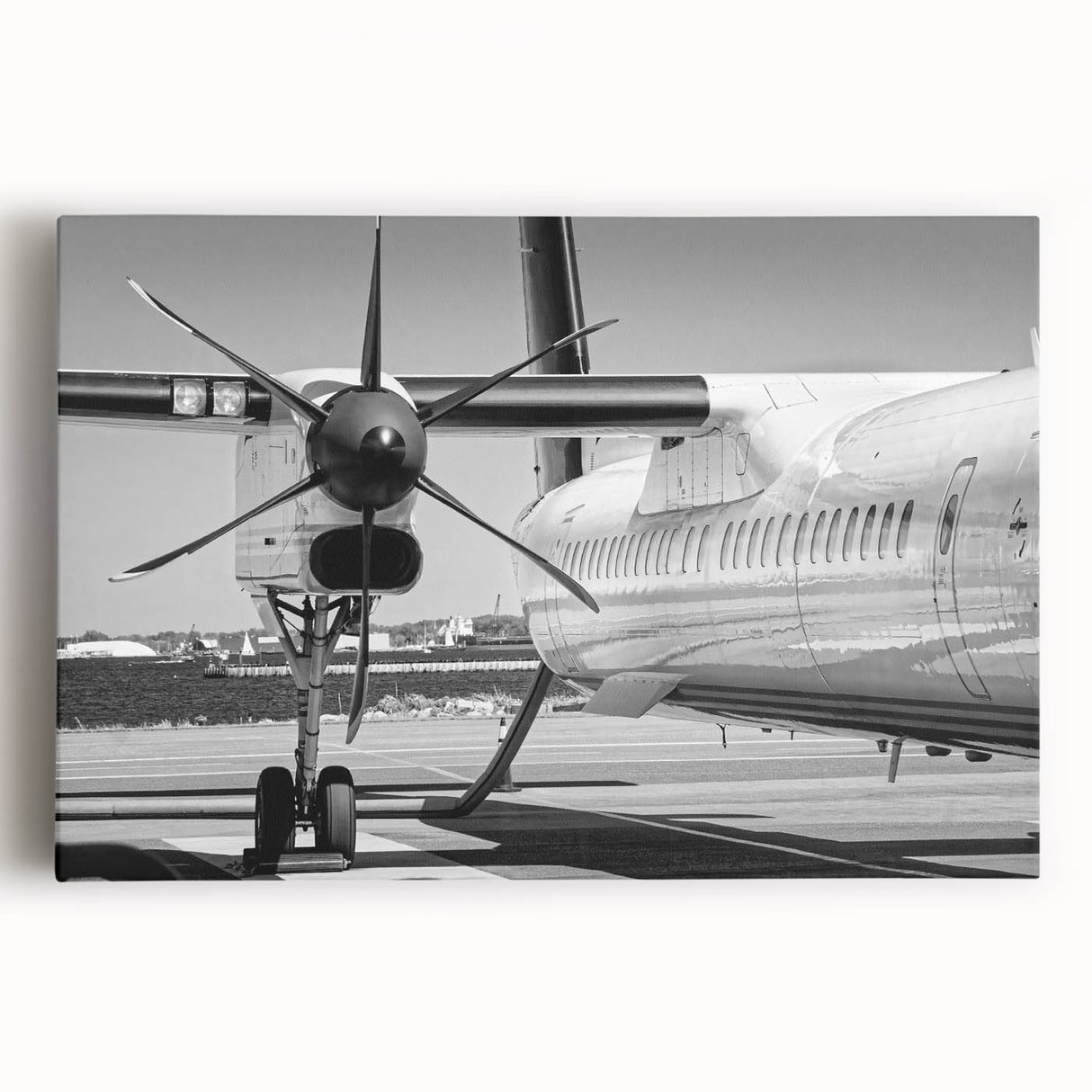 Black and white photograph of an airplane on stretched canvas, ideal for kitchen wall art.