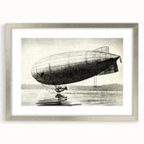 Textured art print of an abstract airship in gray and silver tones, framed with a silver mat, suitable for bedroom decor.