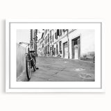 Extra large abstract art print of a bicycle in textured black and white, framed with a white mat.