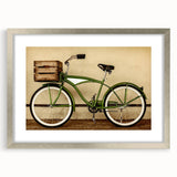 Textured art print of an abstract bicycle in muted gray tones on a framed silver mat, suitable for bedroom decor.