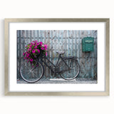 Textured art print of an abstract bicycle in muted gray tones on a silver-framed canvas, suitable for bedroom decor.