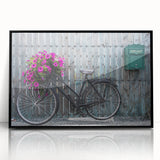Large abstract wall art depicting a bicycle, in muted earth tones on acrylic, framed in black.