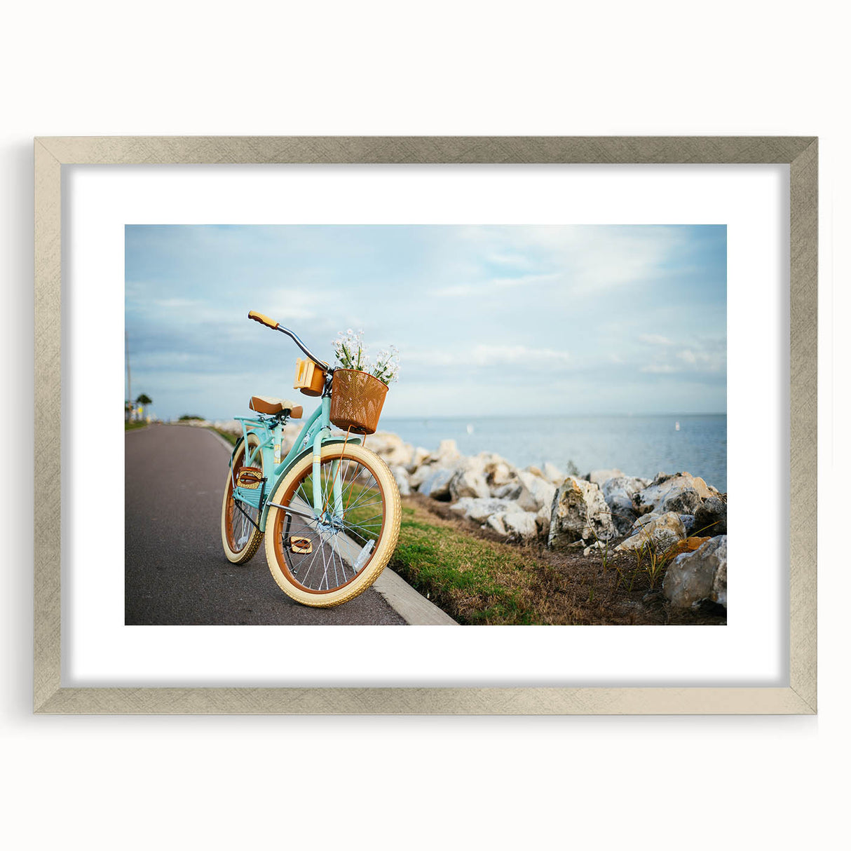 Textured abstract art print of a bicycle in muted gray tones on a silver-framed canvas, suitable for bedroom decor.