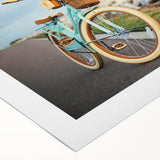 Art Deco poster featuring a vintage bicycle on rolled canvas, in muted earth tones, ideal for dining room decor.