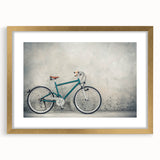 Abstract art print featuring a stylized bicycle in gold and black tones on a framed canvas.