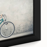 Framed canvas featuring a close-up of a black bicycle on a textured, colorful background.