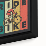 Extra large framed canvas featuring a close-up of a black bicycle on a textured, colorful background.