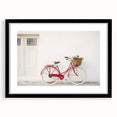 Abstract art print of colorful, textured bicycles on a large canvas, framed in black, ideal for living room decor.