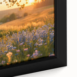 Close-up of a vintage poster-style framed canvas featuring a black bicycle on a muted landscape background.