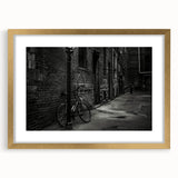 Textured abstract art print of a bicycle in muted gold and black tones on a framed canvas, ideal for bedroom wall decor.
