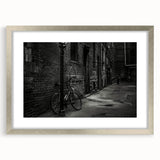 Abstract art print of a bicycle in muted gray and silver tones, framed with a silver mat, ideal for dining room decor.