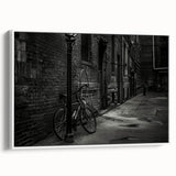 Vintage poster art of a bicycle, featuring black and colorful accents on a white framed canvas, ideal for living room decor.