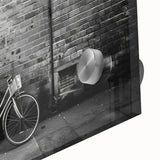 Mid-century modernist art featuring a large abstract bicycle print on acrylic glass, in neutral tones.