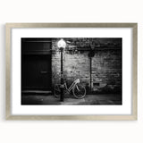 Textured abstract art print of a bicycle in muted earth tones on a framed canvas, suitable for bedroom wall decor.
