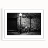 Extra large abstract art print of a bicycle in textured black and white, framed with a white mat.