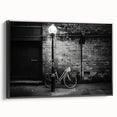 Black and white vintage poster art of a bicycle on framed canvas, ideal for bedroom wall decor.
