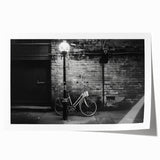 Rolled print of a vintage bicycle with floral accents in soft pastel colors, ideal for art wall dining room or bathroom.