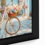 Close-up of a black framed canvas featuring a colorful, textured depiction of a bicycle, ideal for living room decor.