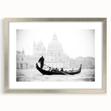 Abstract art print of a stylized gondola in muted blue and gray, framed in silver, suitable for bedroom or dining room decor.