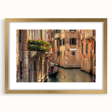 Textured abstract art print of a gondola on water, in muted blue and gold tones, framed in gold, suitable for bedroom decor.
