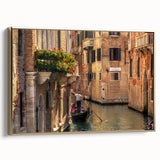 Framed canvas featuring a vintage poster of a gondola in Venice in muted black and gold tones.