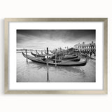 Abstract art print of a gondola on water, using muted blue and gray tones on a silver-framed poster.