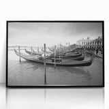 Acrylic print of a gondola on a canal, in muted earth tones, framed in black, suitable for modern art wall decor.