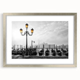 Abstract art print of a stylized gondola in muted blue and gray tones, framed in silver, suitable for dining room decor.