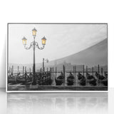 Framed acrylic print of a gondola on calm waters, using a palette of soft blues and grays, ideal for modern art wall decor.