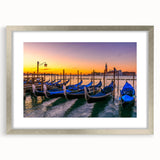 Abstract art print of a gondola on water in muted blues and grays, framed in silver, suitable for dining room decor.