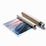 Rolled print of a rowboat on calm waters in muted blue and gray tones, suitable for bathroom decor.