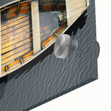 Acrylic print of a rowboat on water in muted blue and gray tones.