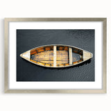 Abstract art print of a rowboat in muted blue tones on a framed canvas, suitable for dining room decor.