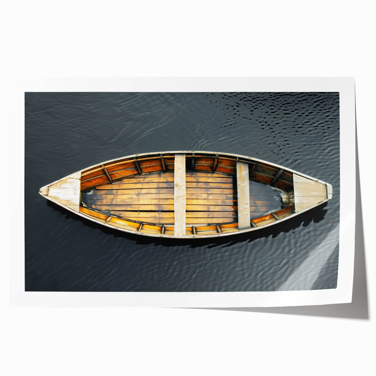Rolled print of a rowboat on calm waters in muted blue and gray tones, ideal for dining room wall art.