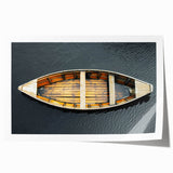 Rolled print of a rowboat on calm waters in muted blue and gray tones, ideal for dining room wall art.