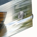 Large abstract wall art of a rowboat in muted blues and greens on acrylic glass, suitable for dining room ambiance.