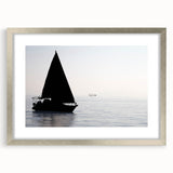 Abstract art print of a stylized sailboat in cool blue tones on a silver-framed canvas, ideal for dining room decor.