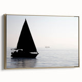 Framed canvas featuring a vintage-style sailboat on a colorful, abstract sea.