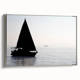 Vintage poster art of a sailboat, rendered in colorful art on a black background, framed in silver.