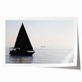 Sailboat on calm waters in muted blue and white hues on a rolled canvas, ideal for dining room wall art.