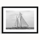 Abstract art print featuring a colorful, textured depiction of sailboats, framed in black.