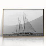 Mid-century modernist art depicting a sailboat, in muted blue and white tones on a framed acrylic.
