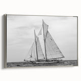 Vintage poster art of a sailboat, rendered in colorful art on a black background, framed in silver.