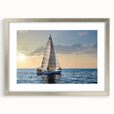 Abstract art print of a stylized sailboat in silver frame, using cool blue and white tones.