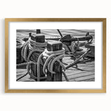 Textured abstract art print of a sailboat in muted blue and white tones on a gold-framed canvas, ideal for bedroom art.