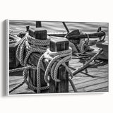 Framed canvas featuring a vintage-style sailboat on a tranquil sea.