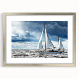 Abstract art print of a sailboat in silver frame, with cool blue and white tones, ideal for dining room decor.